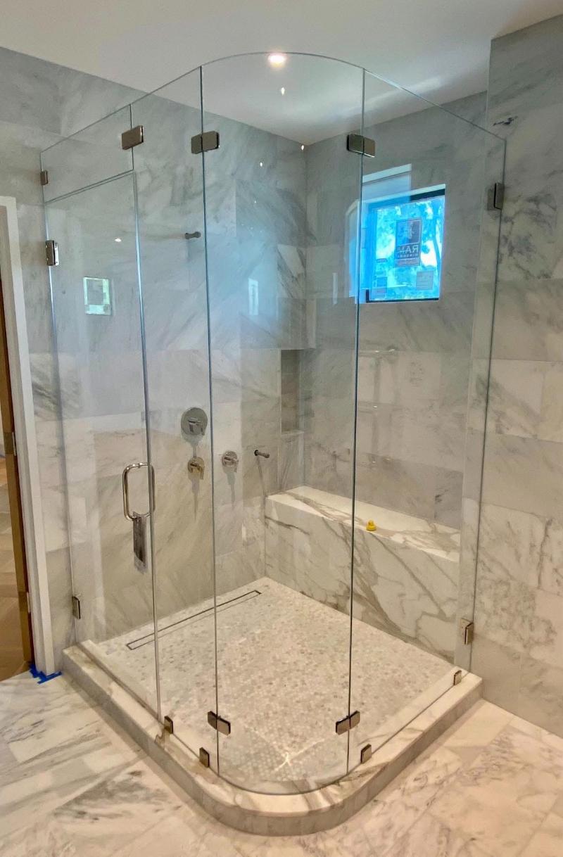 Custom Corner Shower Enclosure Featuring Curved Glass in Austin, TX